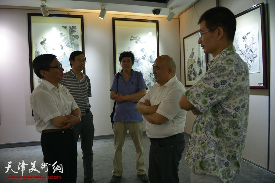 “诗画入境——闫勇国画作品展”8月17日在天津图书大厦六楼书天艺苑开幕。图为史玉健、尹沧海、王春涛、路洪明、姜金军等在画展现场。