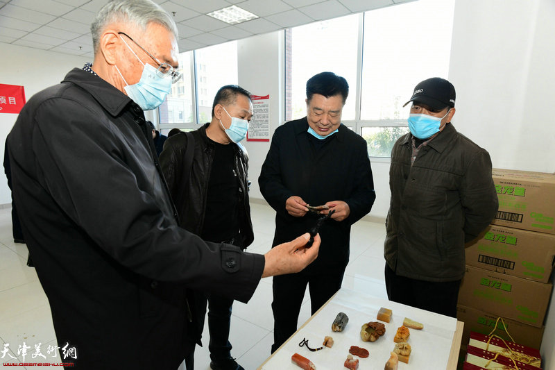 程怀金、赵玉森在活动现场观赏印石雕刻艺术家祁克勤、卢东的作品。